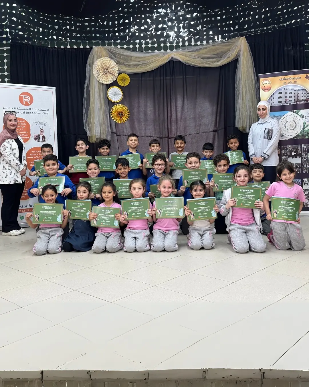 مجموعة من أطفال TPR يحملون شهاداتهم